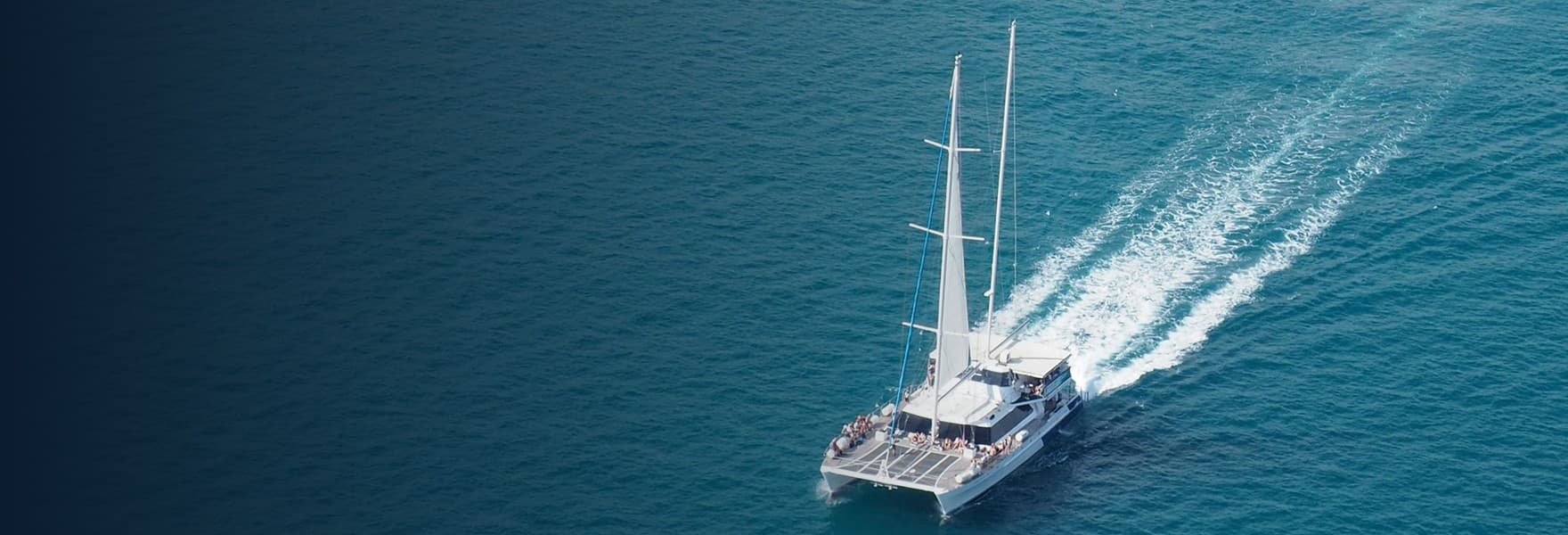 Motor yacht cruising close to Mallorca’s rocky coastline