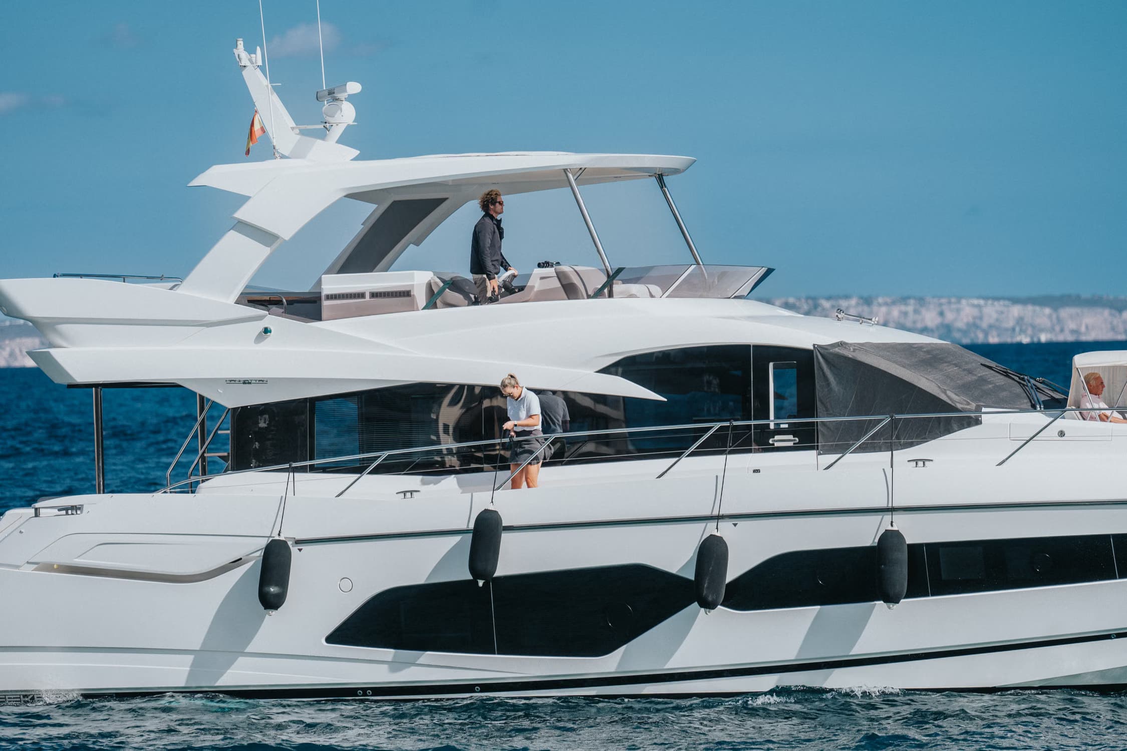 Guests aboard a motor yacht cruising near Palma